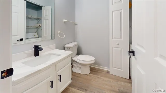a bathroom with a sink toilet and a mirror