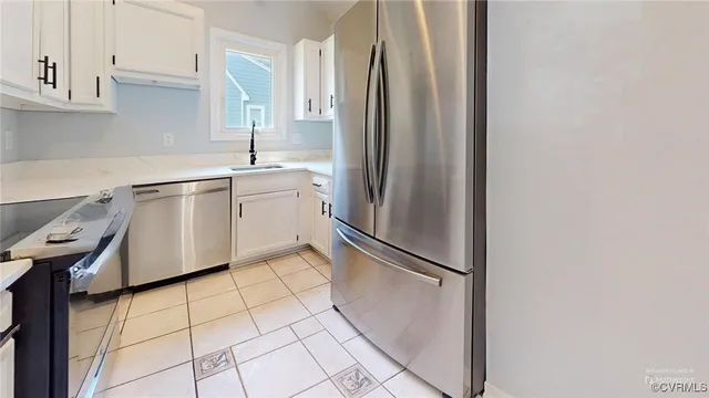 a kitchen with cabinets appliances a sink and a window