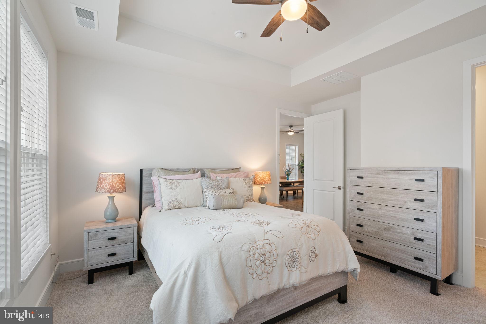 14712 Grand Cru Loop Gainesville, VA 20155 - Photo 15 of 46 a bedroom with a bed and a ceiling fan