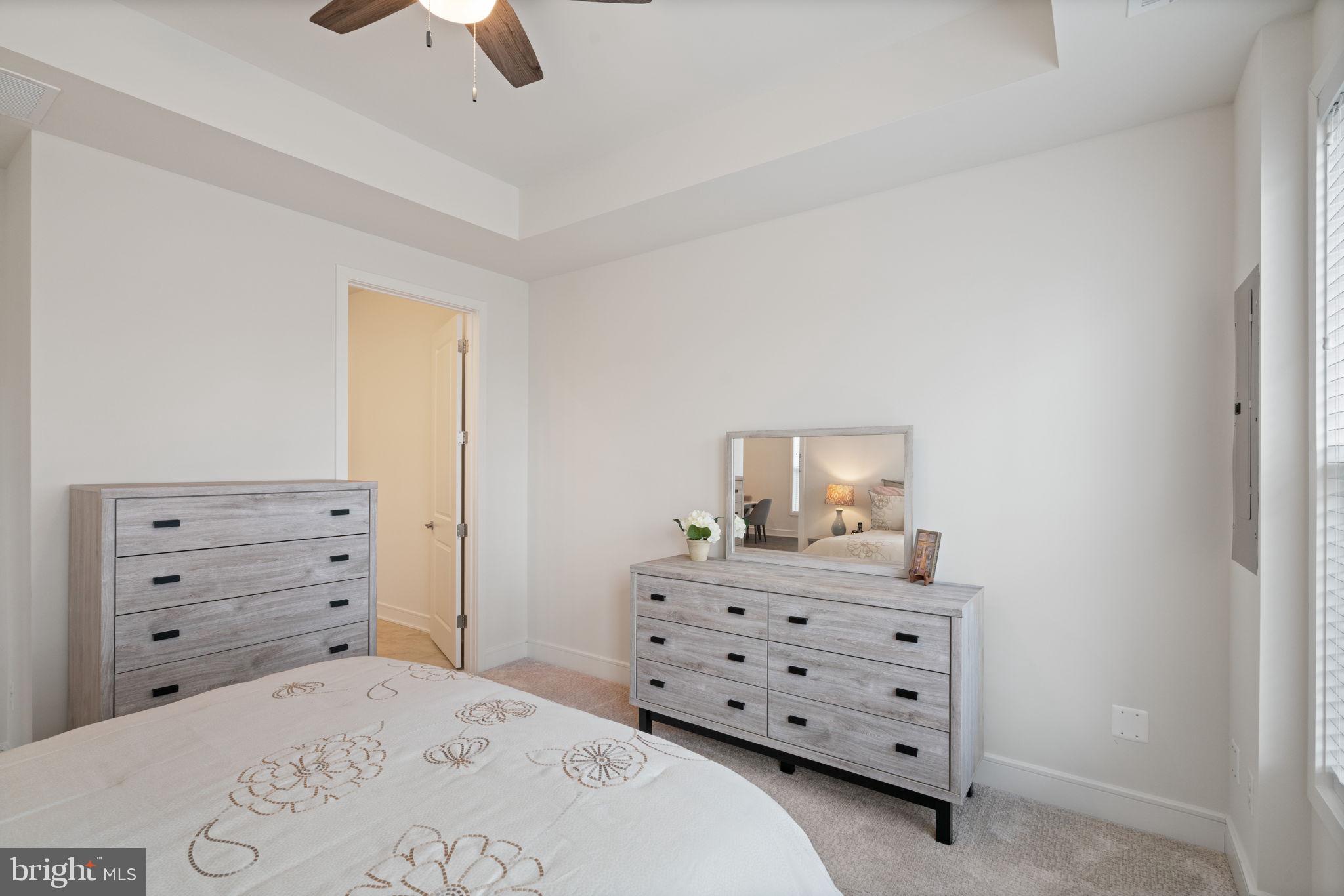 14712 Grand Cru Loop Gainesville, VA 20155 - Photo 17 of 46 a bedroom with a bed and a dresser