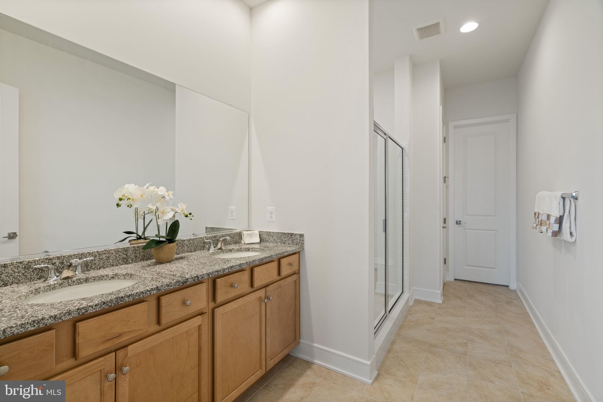14712 Grand Cru Loop Gainesville, VA 20155 - Photo 18 of 46 a bathroom with a granite countertop sink and a mirror