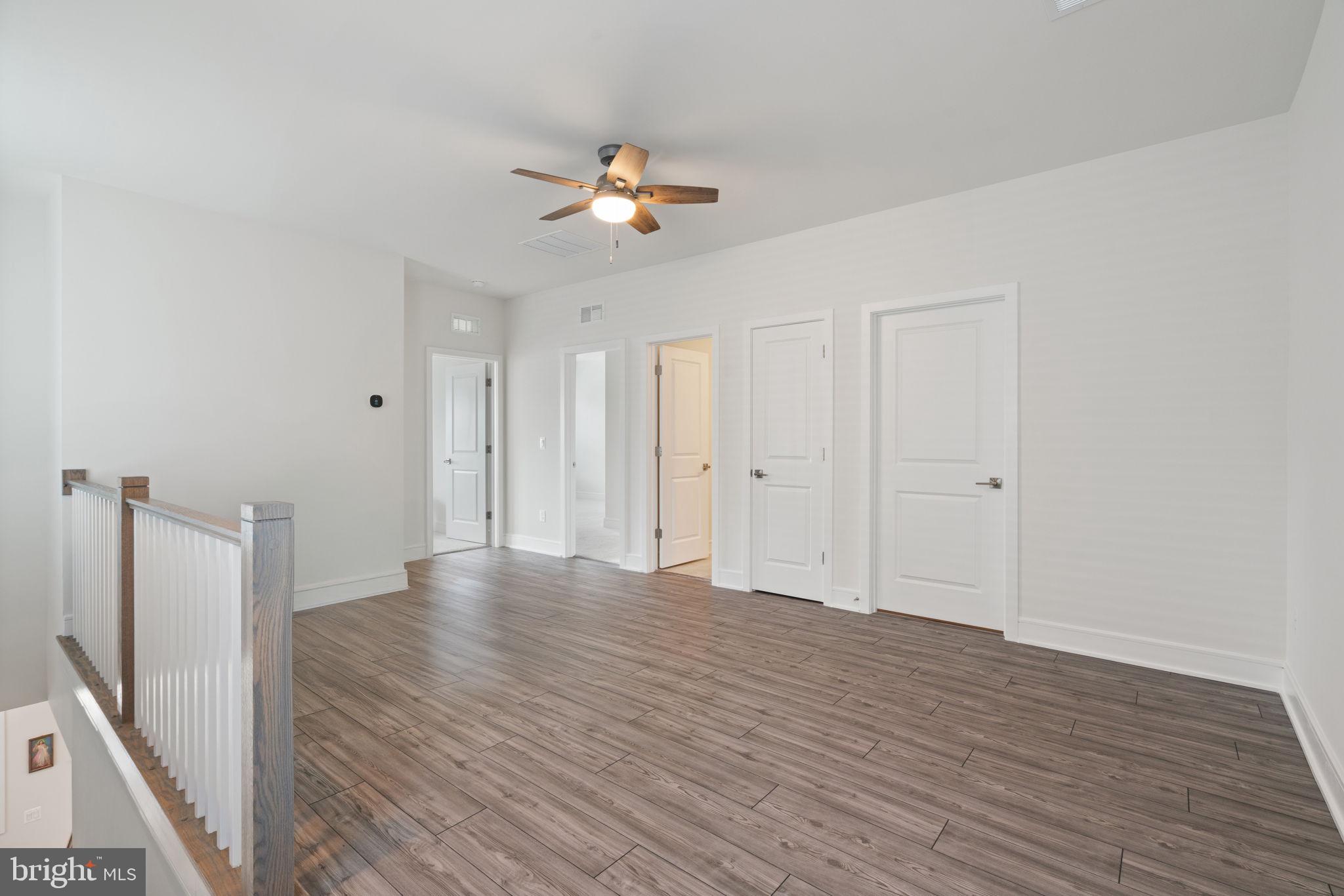 14712 Grand Cru Loop Gainesville, VA 20155 - Photo 26 of 46 a view of an empty room with wooden floor