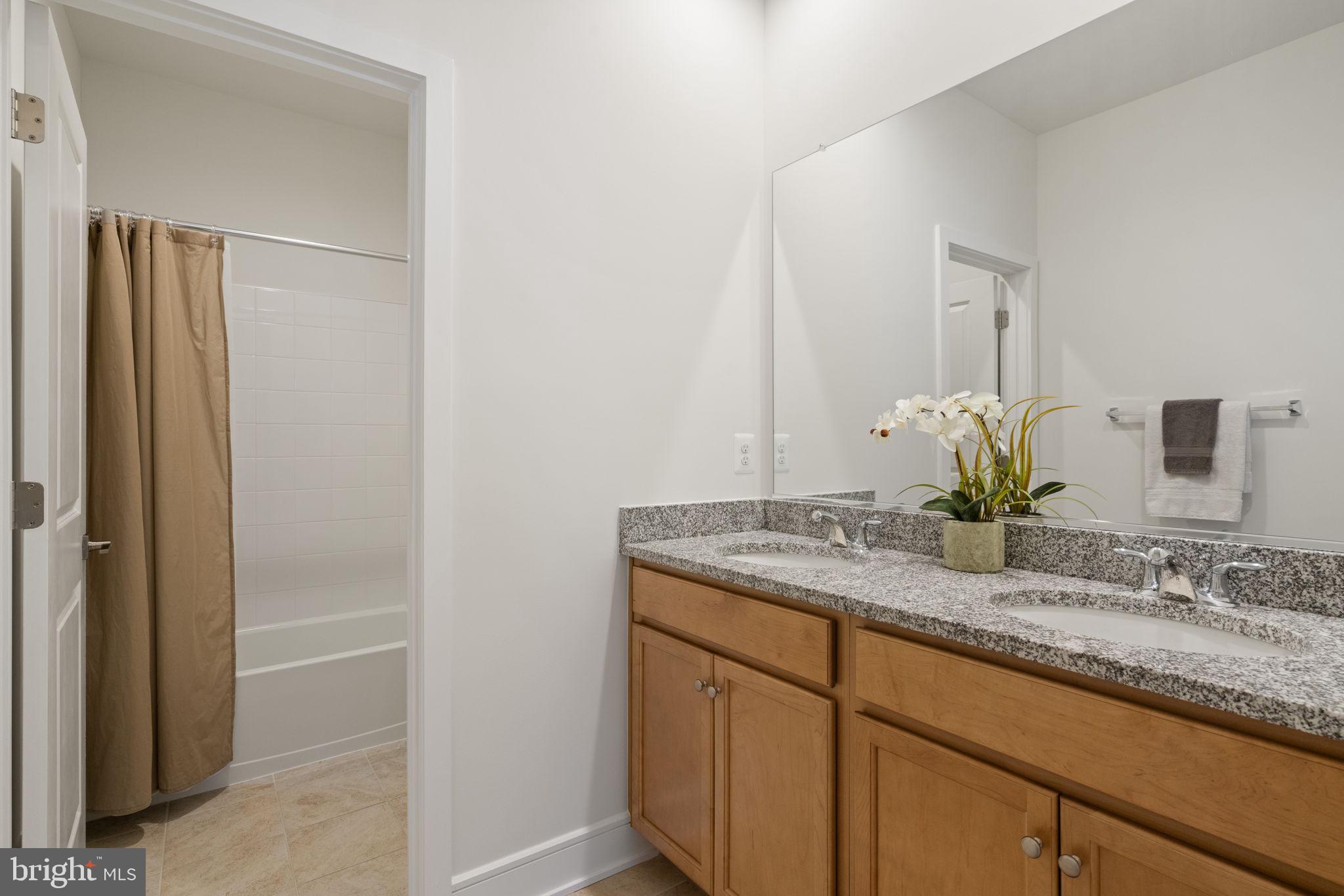 14712 Grand Cru Loop Gainesville, VA 20155 - Photo 34 of 46 a bathroom with a granite countertop sink and a mirror