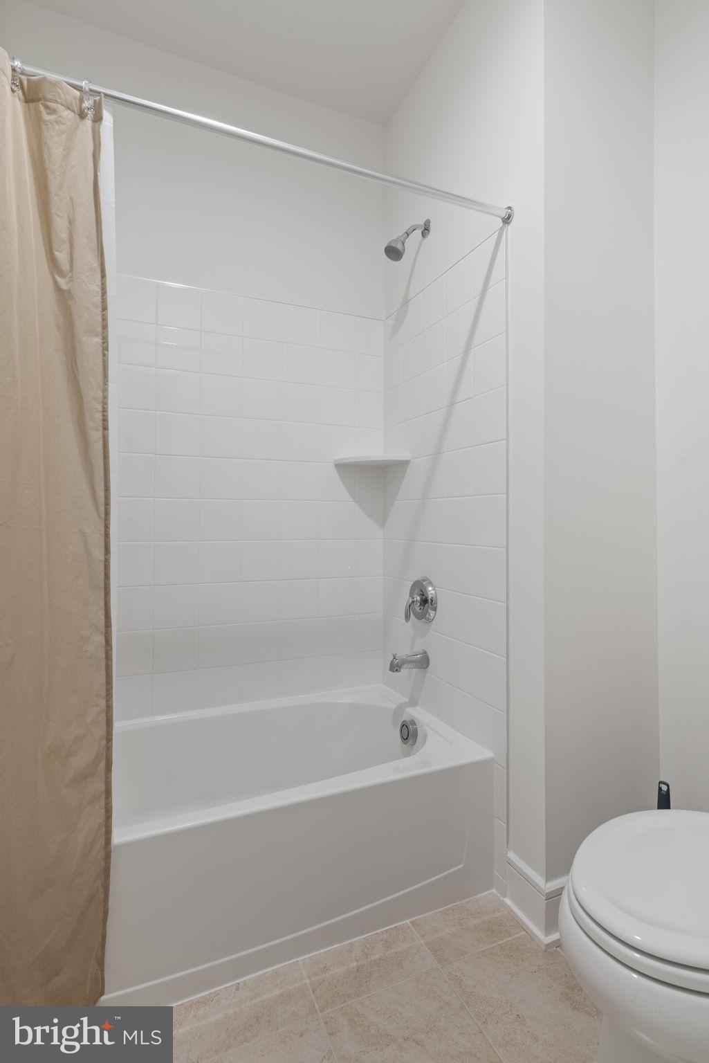 14712 Grand Cru Loop Gainesville, VA 20155 - Photo 35 of 46 a white bath tub and a shower curtain
