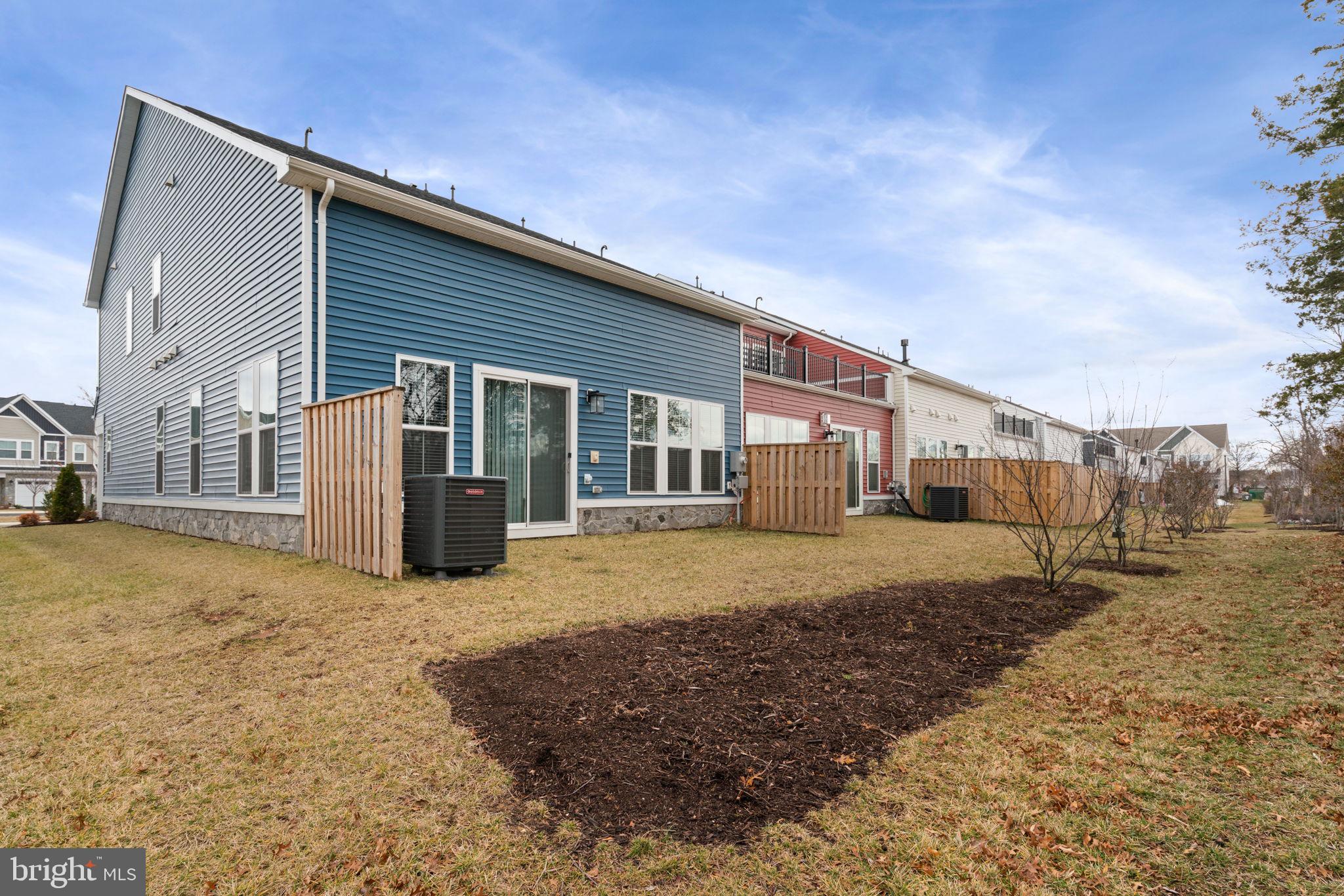 14712 Grand Cru Loop Gainesville, VA 20155 - Photo 39 of 46 a view of a house with a backyard
