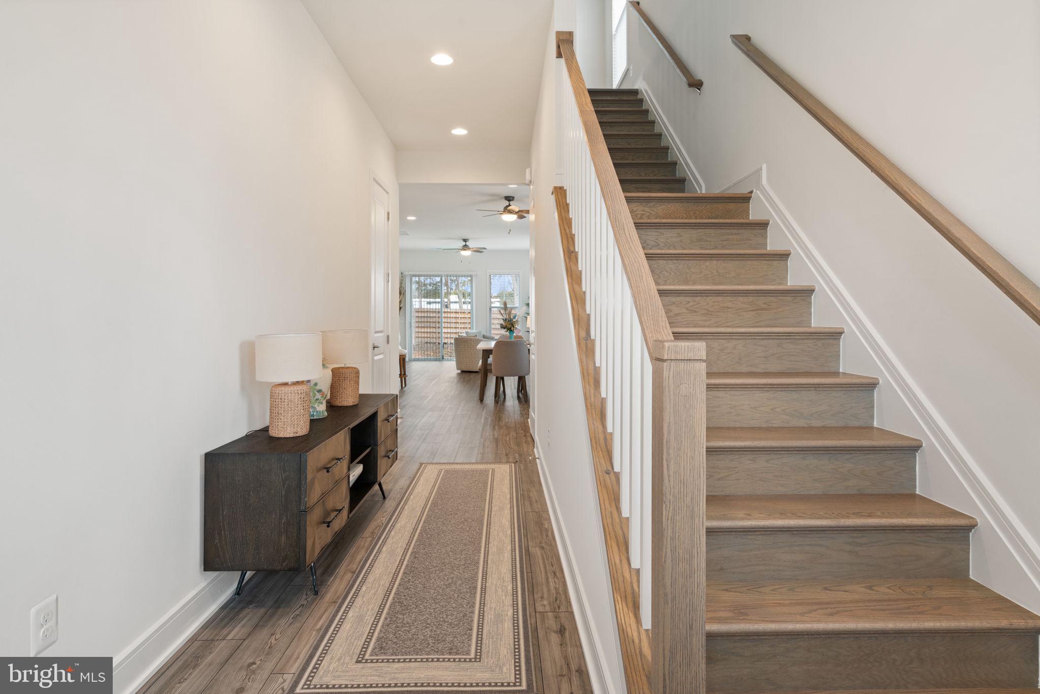 14712 Grand Cru Loop Gainesville, VA 20155 - Photo 4 of 46 a view of a hallway with wooden floor and staircase