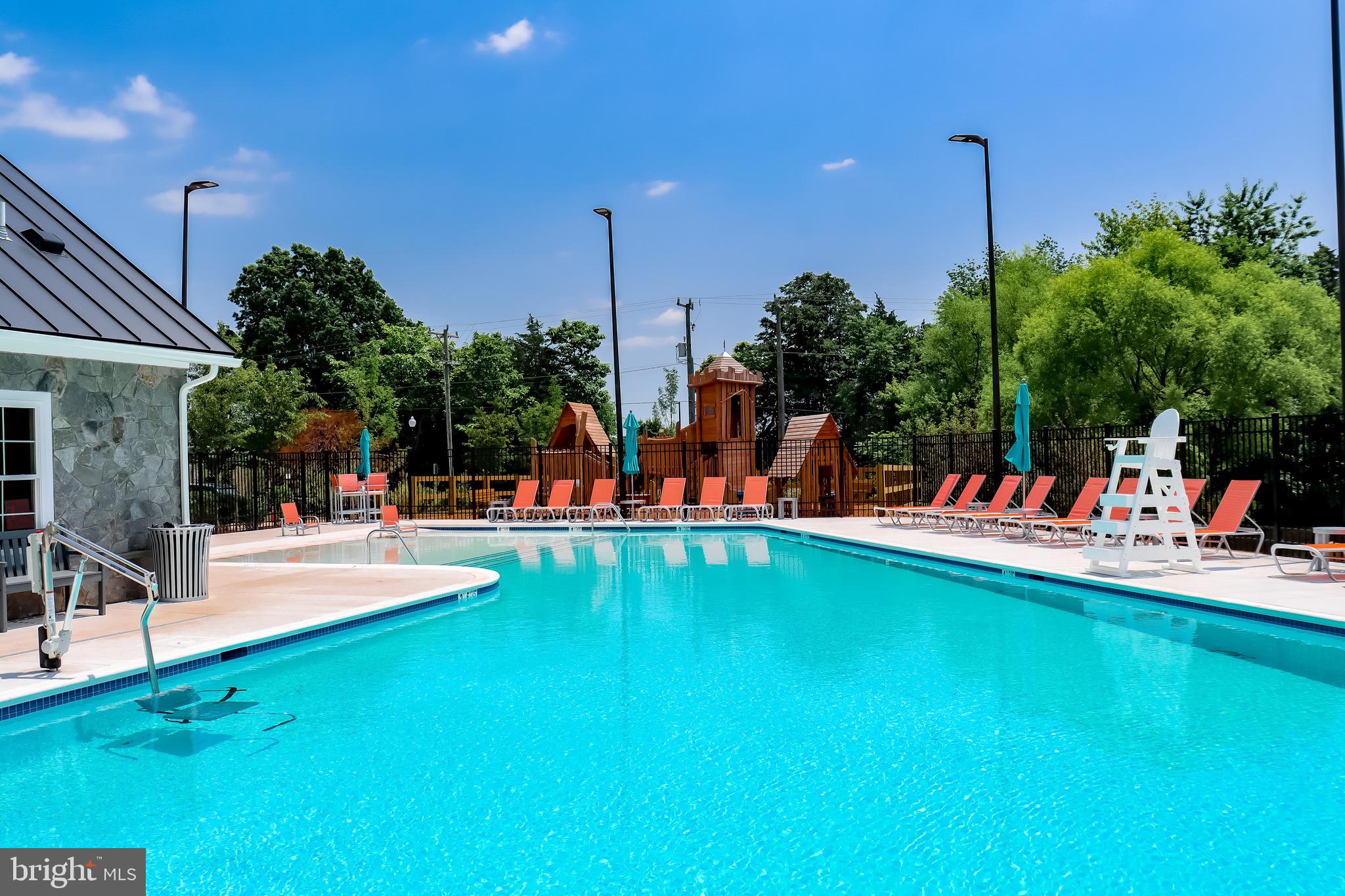 14712 Grand Cru Loop Gainesville, VA 20155 - Photo 42 of 46 a view of a swimming pool with a table and chairs