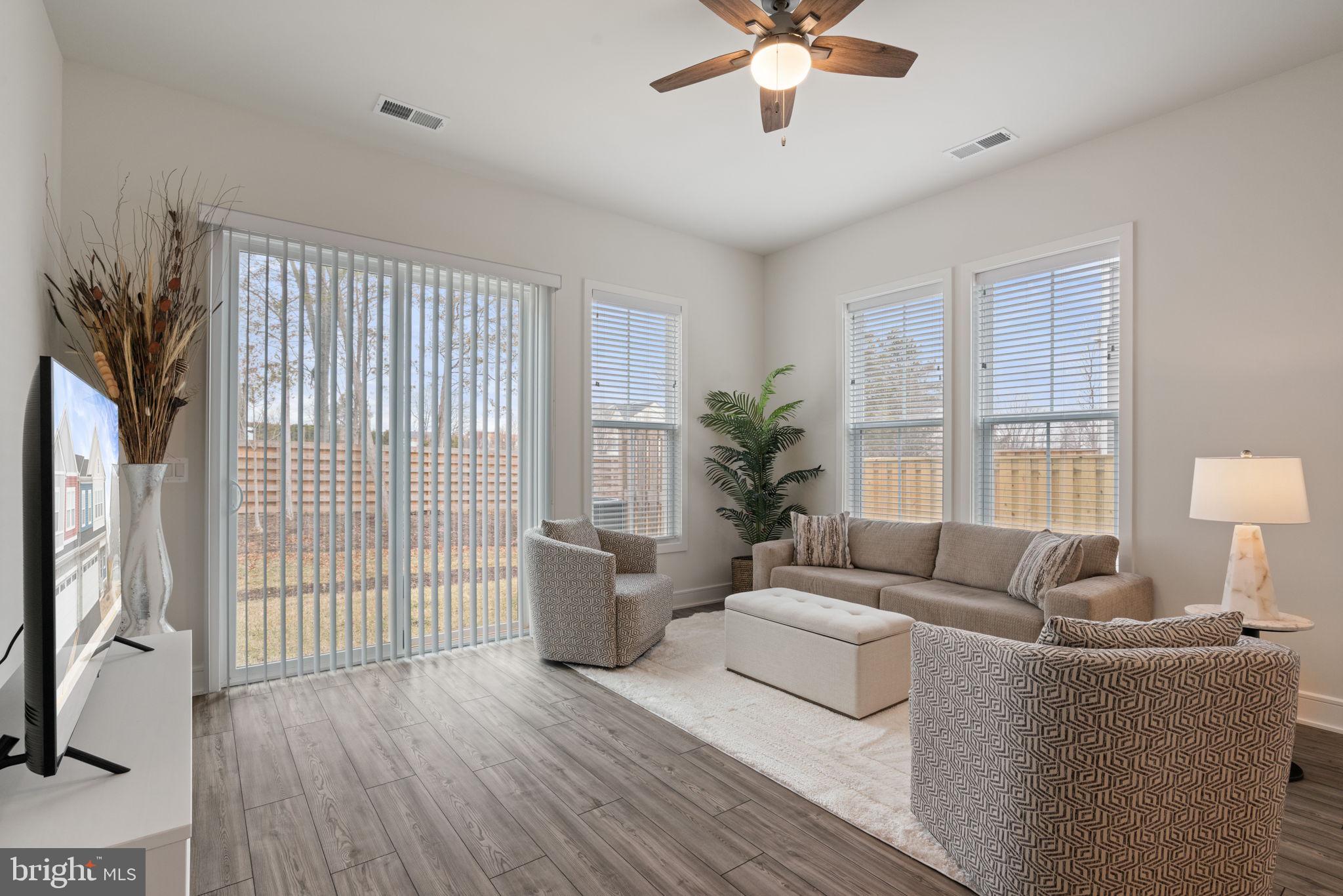 14712 Grand Cru Loop Gainesville, VA 20155 - Photo 8 of 46 a living room with furniture and a large window