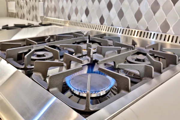 a kitchen with stainless steel appliances granite countertop a stove refrigerator and cabinets