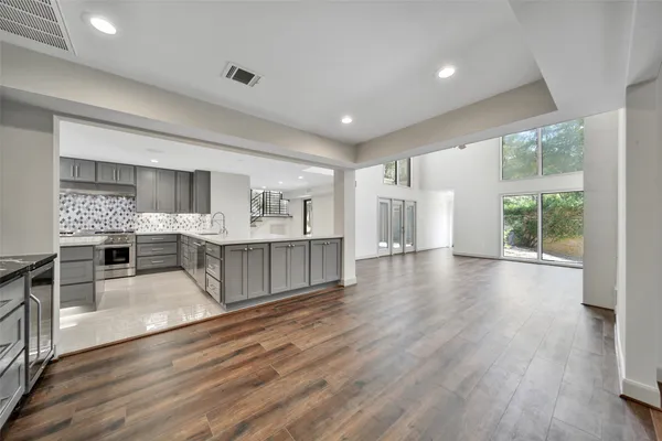 a kitchen with stainless steel appliances granite countertop a stove and cabinets