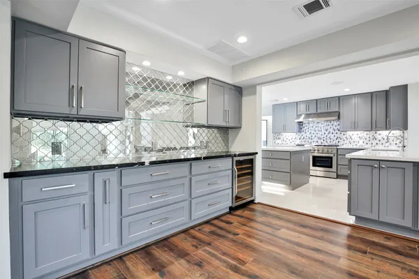 a kitchen with stainless steel appliances granite countertop a stove and cabinets