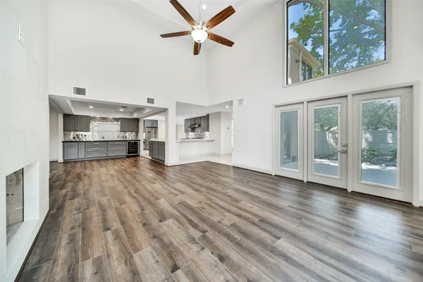 a view of empty room with wooden floor and window