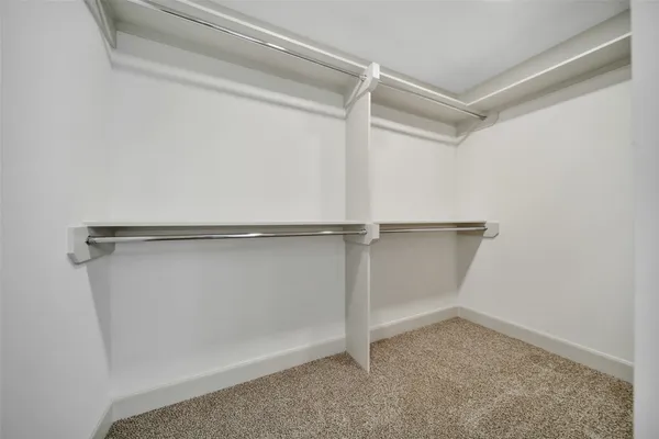 a spacious bathroom with a double vanity sink and mirror