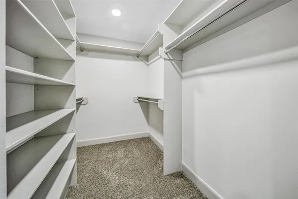 an empty room with a bathroom and a sink