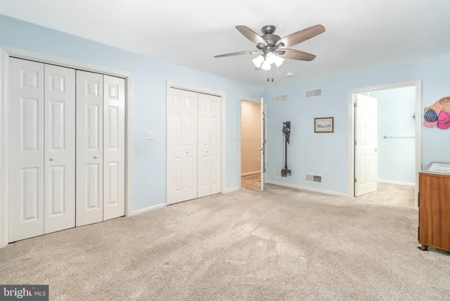 a view of an empty room with a ceiling fan