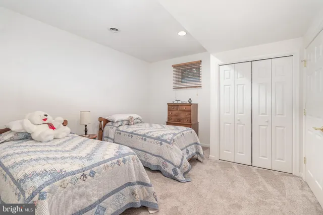 a bathroom with a sink vanity mirror and toilet