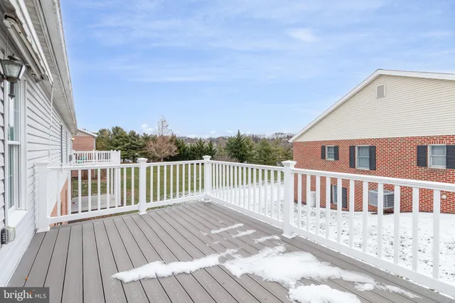 a view of a wooden deck and a floor to ceiling window