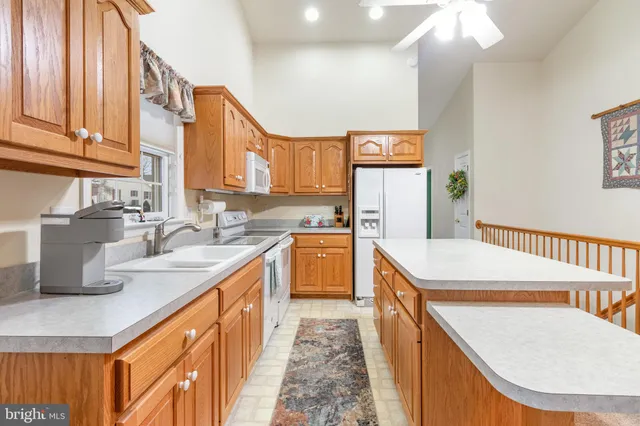 a kitchen with stainless steel appliances granite countertop a sink and cabinets