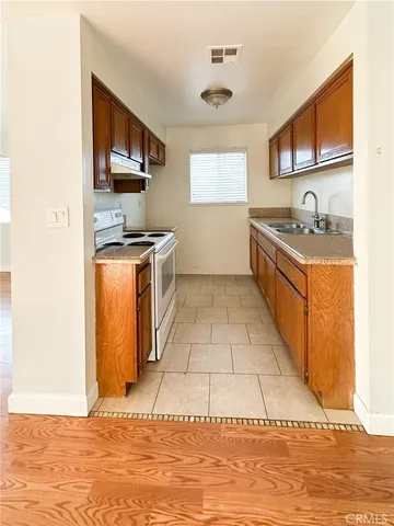 a kitchen with stainless steel appliances granite countertop a sink stove and microwave