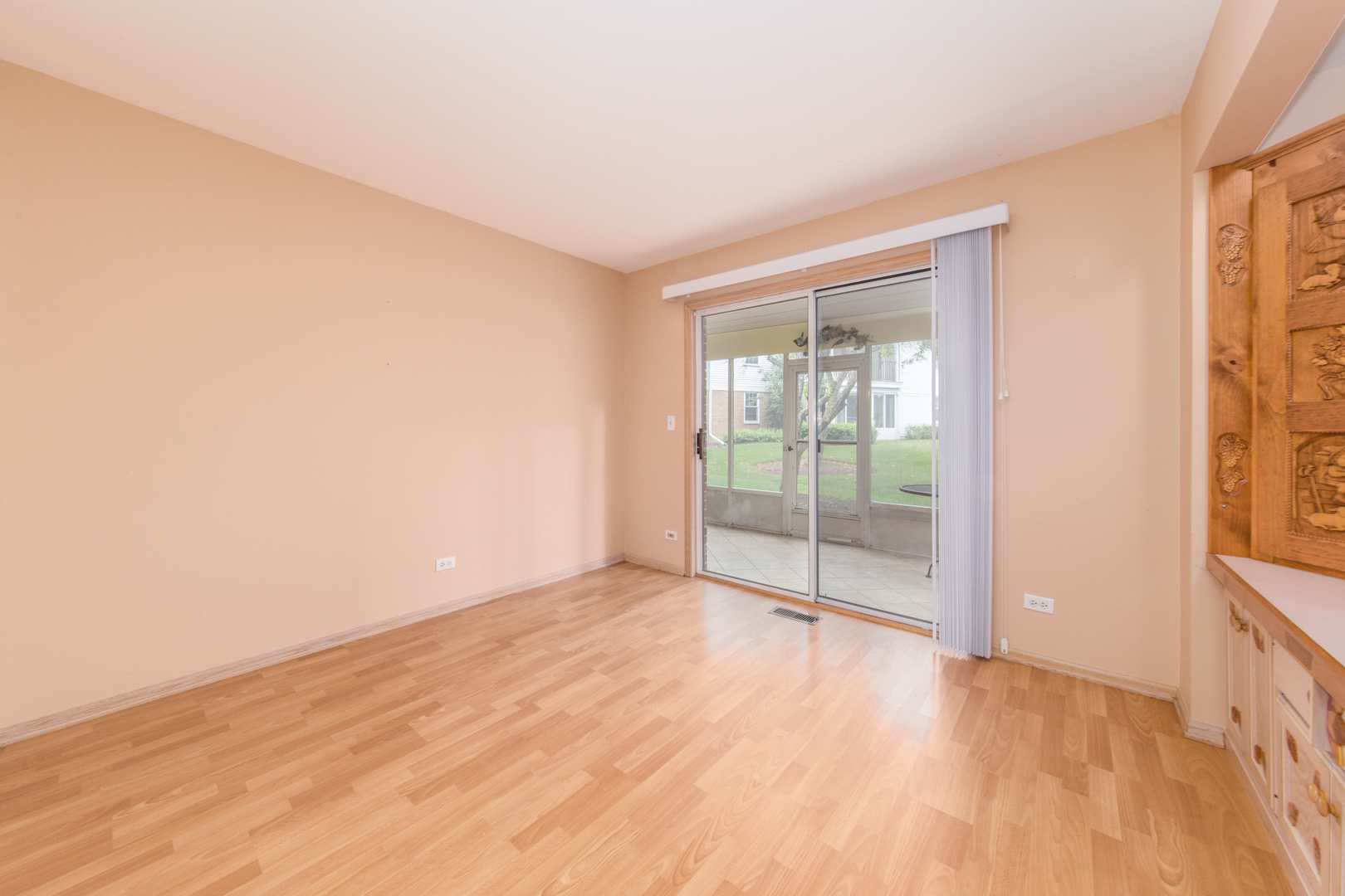 910 Persimmon Lane, Unit B Mount Prospect, IL 60056 - Photo 19 of 31 a view of an empty room with wooden floor and a window