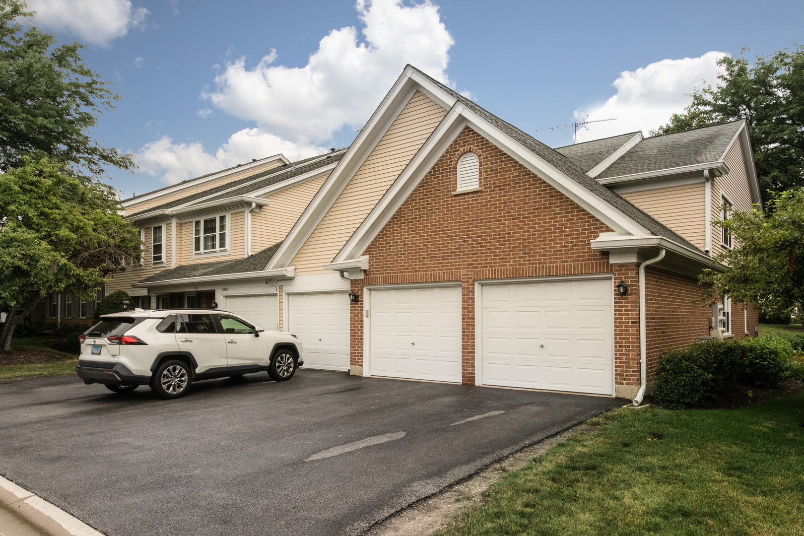 910 Persimmon Lane, Unit B Mount Prospect, IL 60056 - Photo 2 of 31 a car parked in front of white house