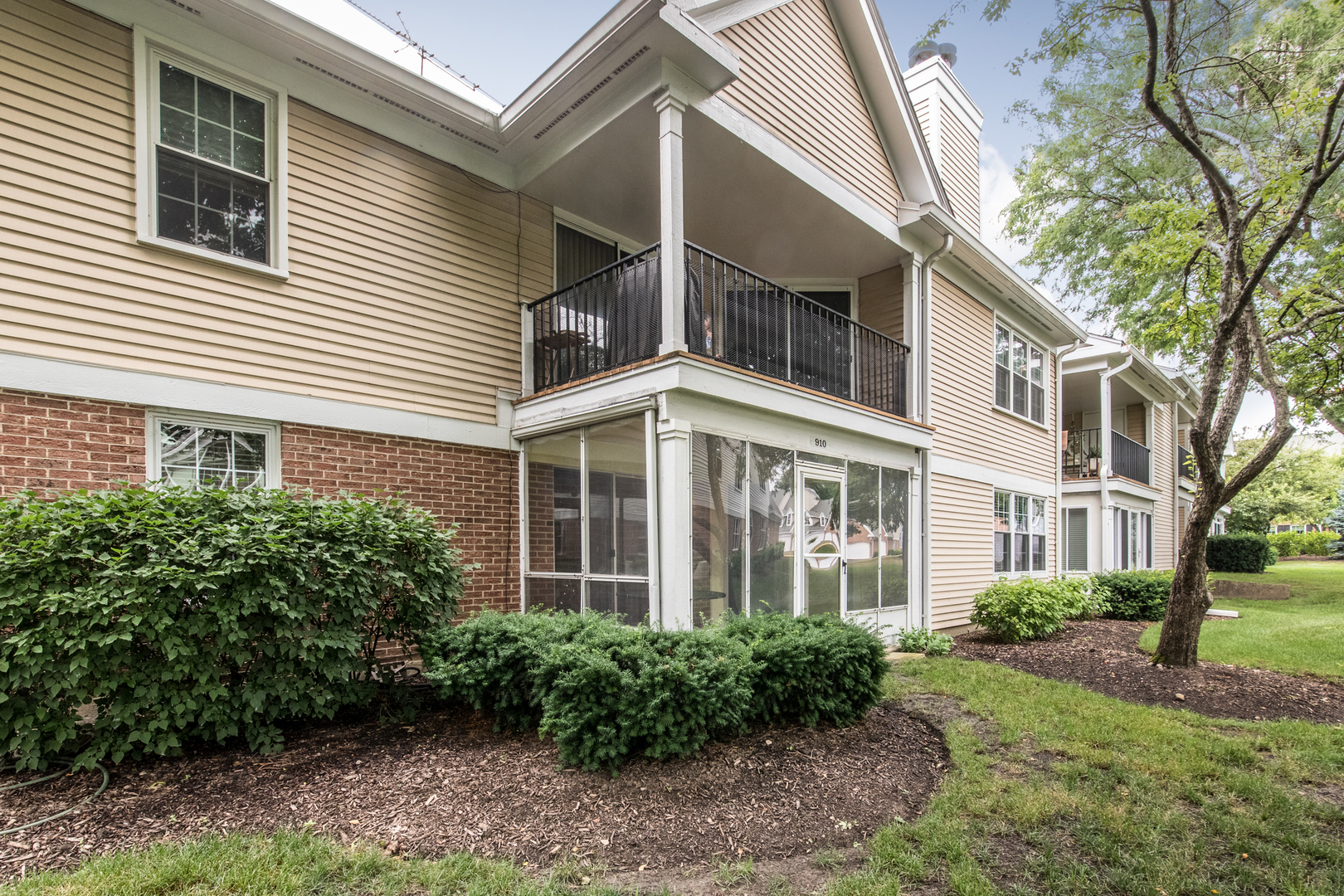 910 Persimmon Lane, Unit B Mount Prospect, IL 60056 - Photo 26 of 31 a view of a building next to a yard