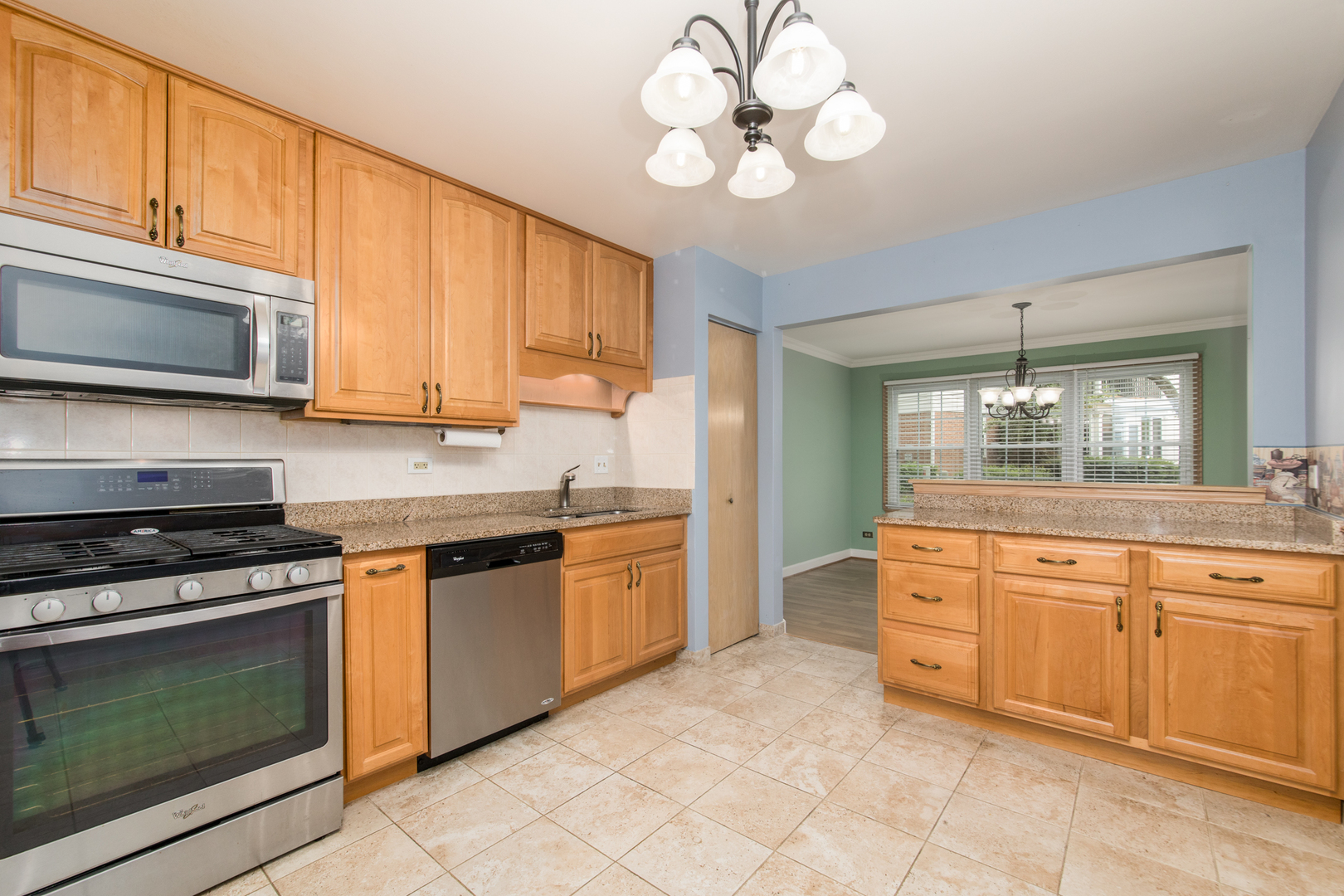 910 Persimmon Lane, Unit B Mount Prospect, IL 60056 - Photo 9 of 31 a kitchen with stainless steel appliances granite countertop a stove and cabinets