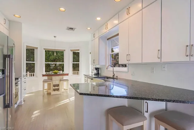 a view of a kitchen and dining area with chandelier