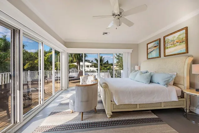 a bedroom with a large bed and a large window