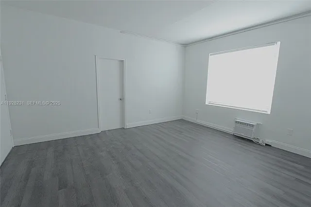 an empty room with wooden floor