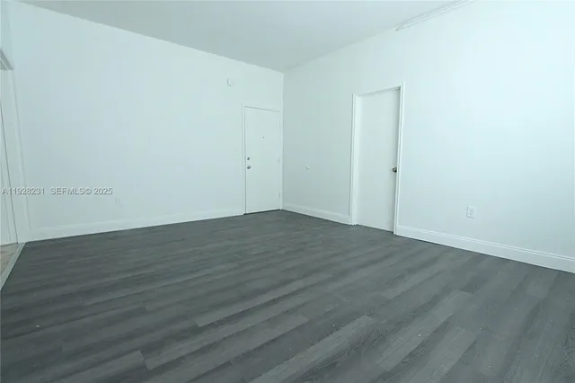 an empty room with wooden floor
