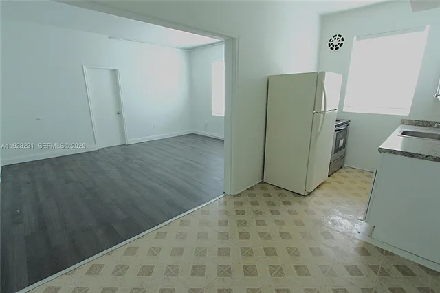 a kitchen with stainless steel appliances a refrigerator and a stove