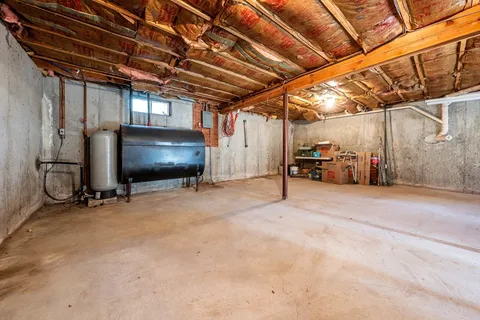 a view of the room with wooden floor and windows