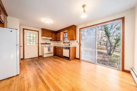 a view of a kitchen with a stove cabinets and a wooden floor