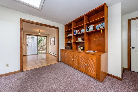 a view of workspace with wooden floor and cabinet