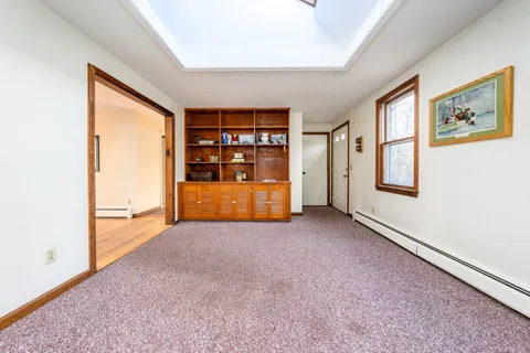 a view of an empty room with closet and workspace