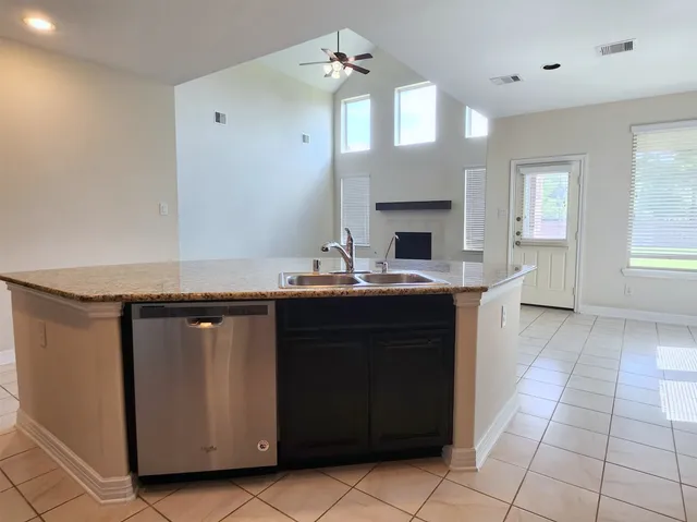 a kitchen with a sink and cabinets