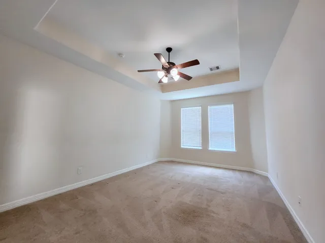 a view of room with ceiling fan and window
