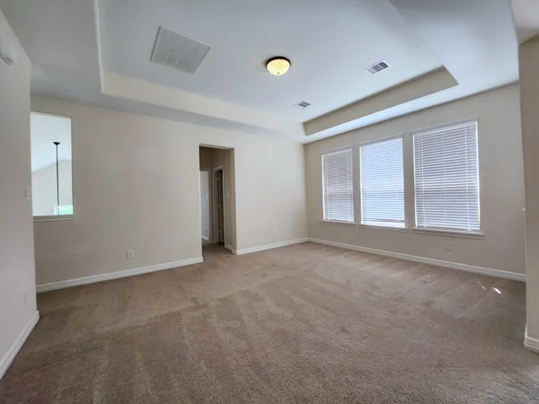 an empty room with windows and closet