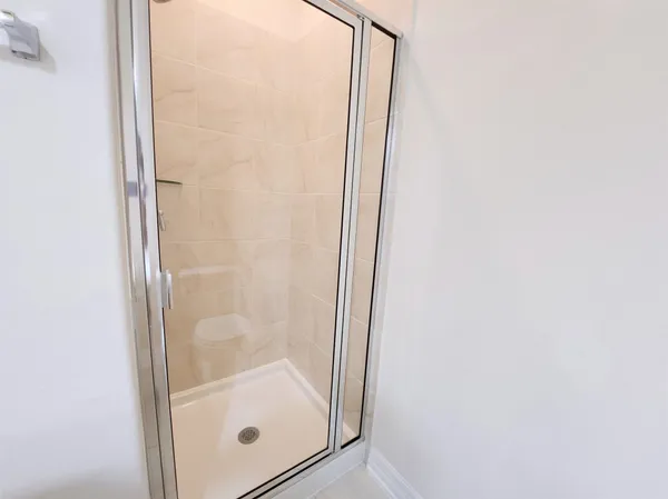 a bathroom with a glass shower door