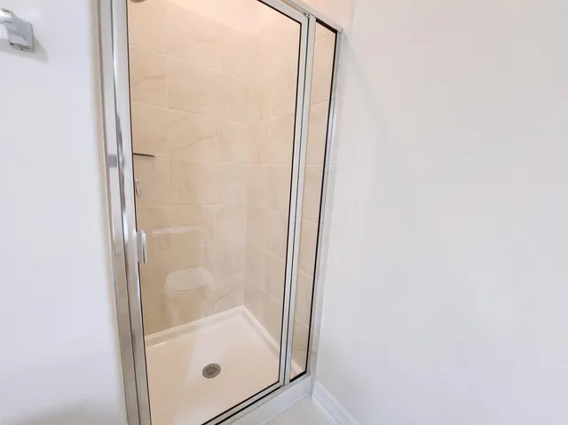 a bathroom with a glass shower door