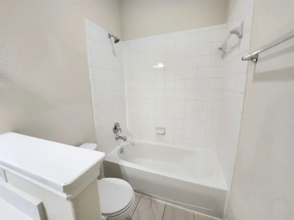 a bathroom with a sink a toilet and a bathtub