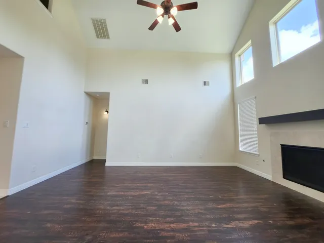 wooden floor in an empty room with a fireplace