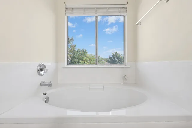a white bath tub sitting next to a window