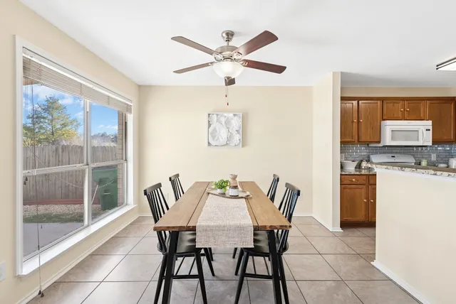 a dining room with furniture and window