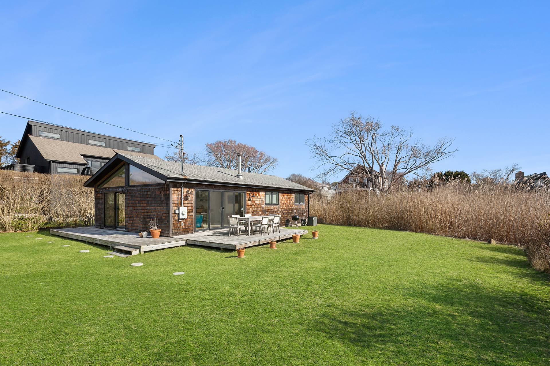 a view of a chair and table in backyard of the house
