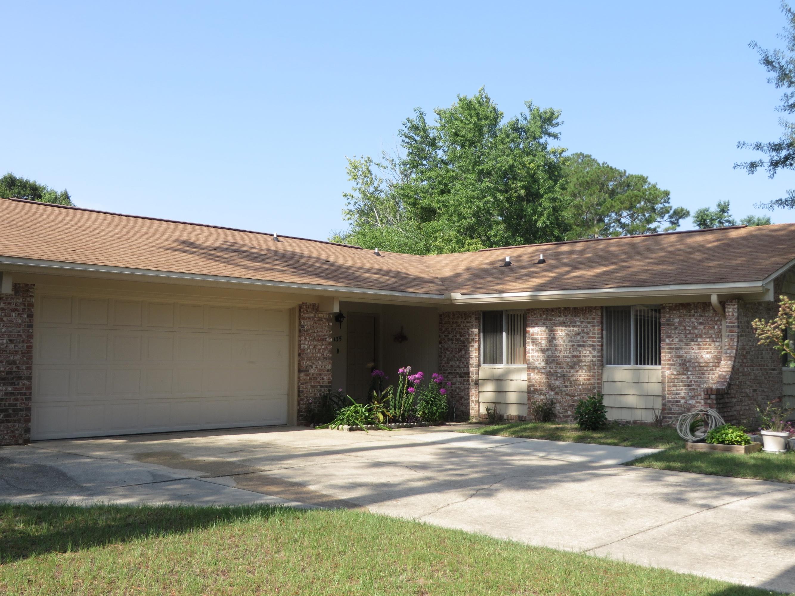a view of a house with a yard and plants