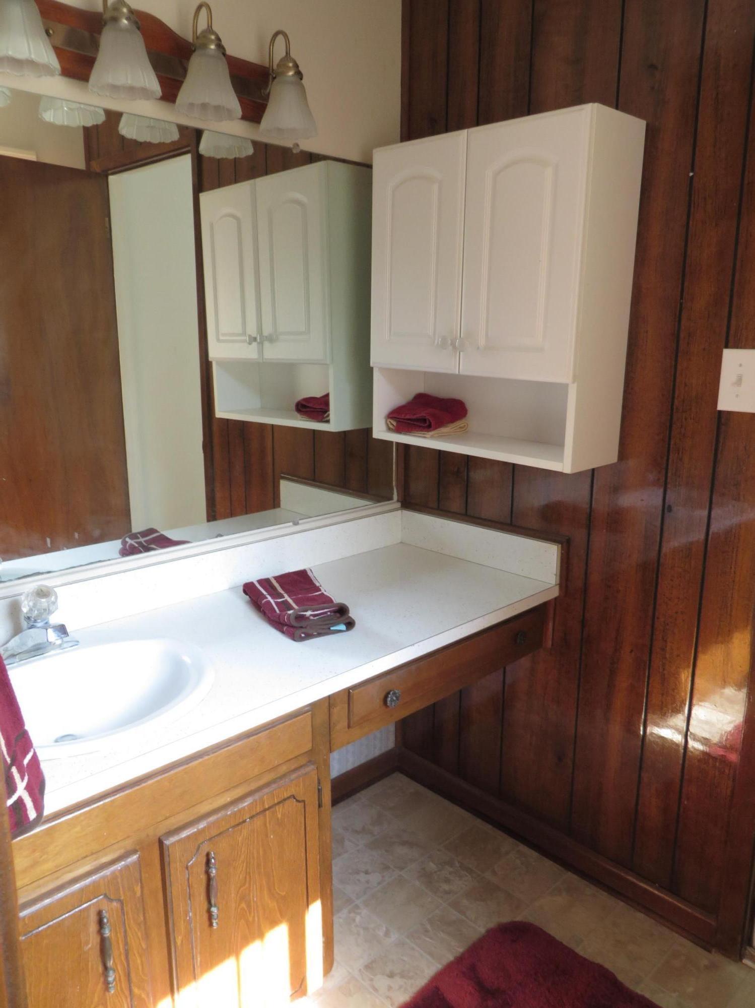 135 Perdido Circle Niceville, FL 32578 - Photo 21 of 28 a bathroom with a sink and a mirror