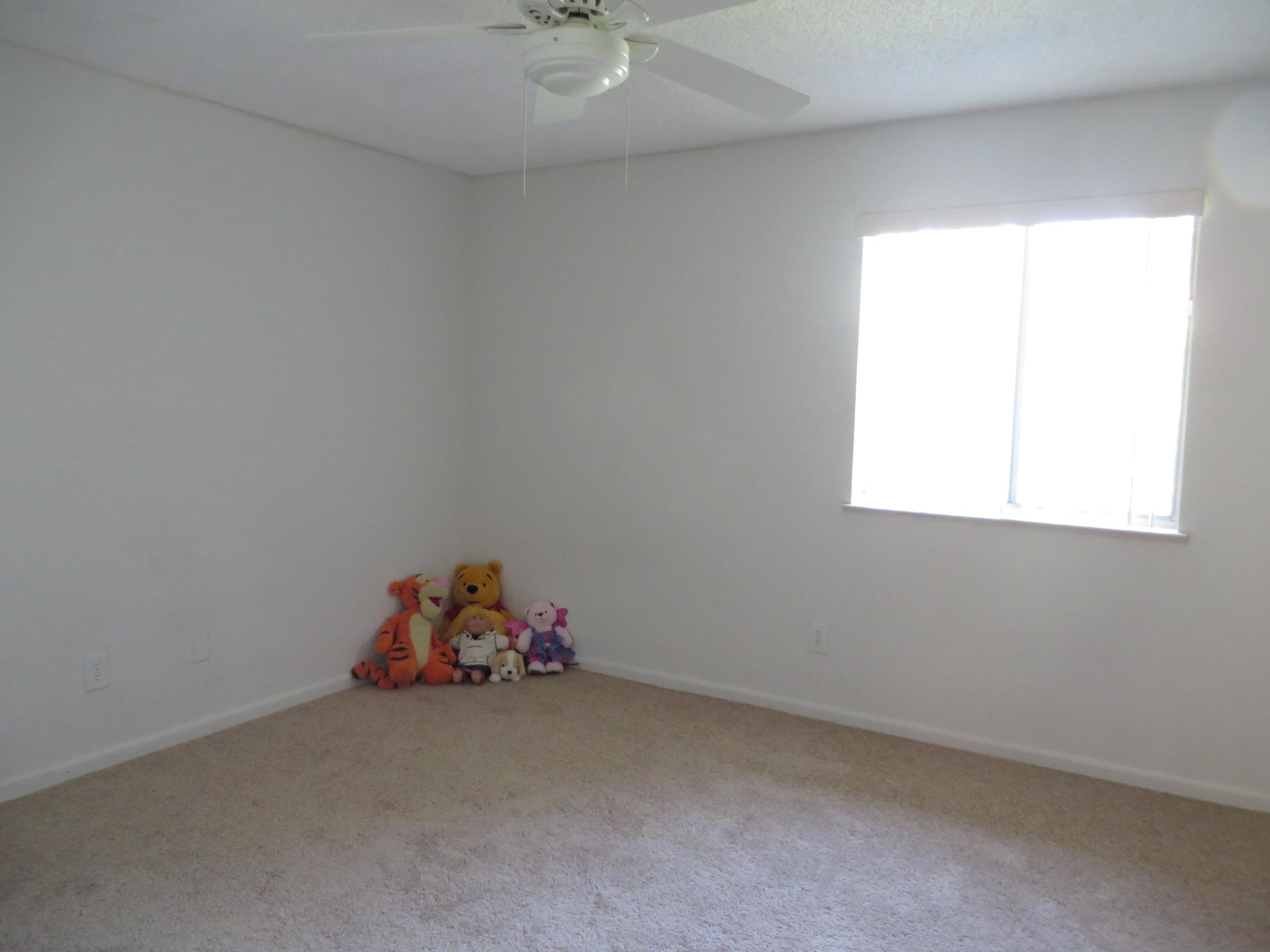 135 Perdido Circle Niceville, FL 32578 - Photo 22 of 28 a room with a window and a chandelier fan