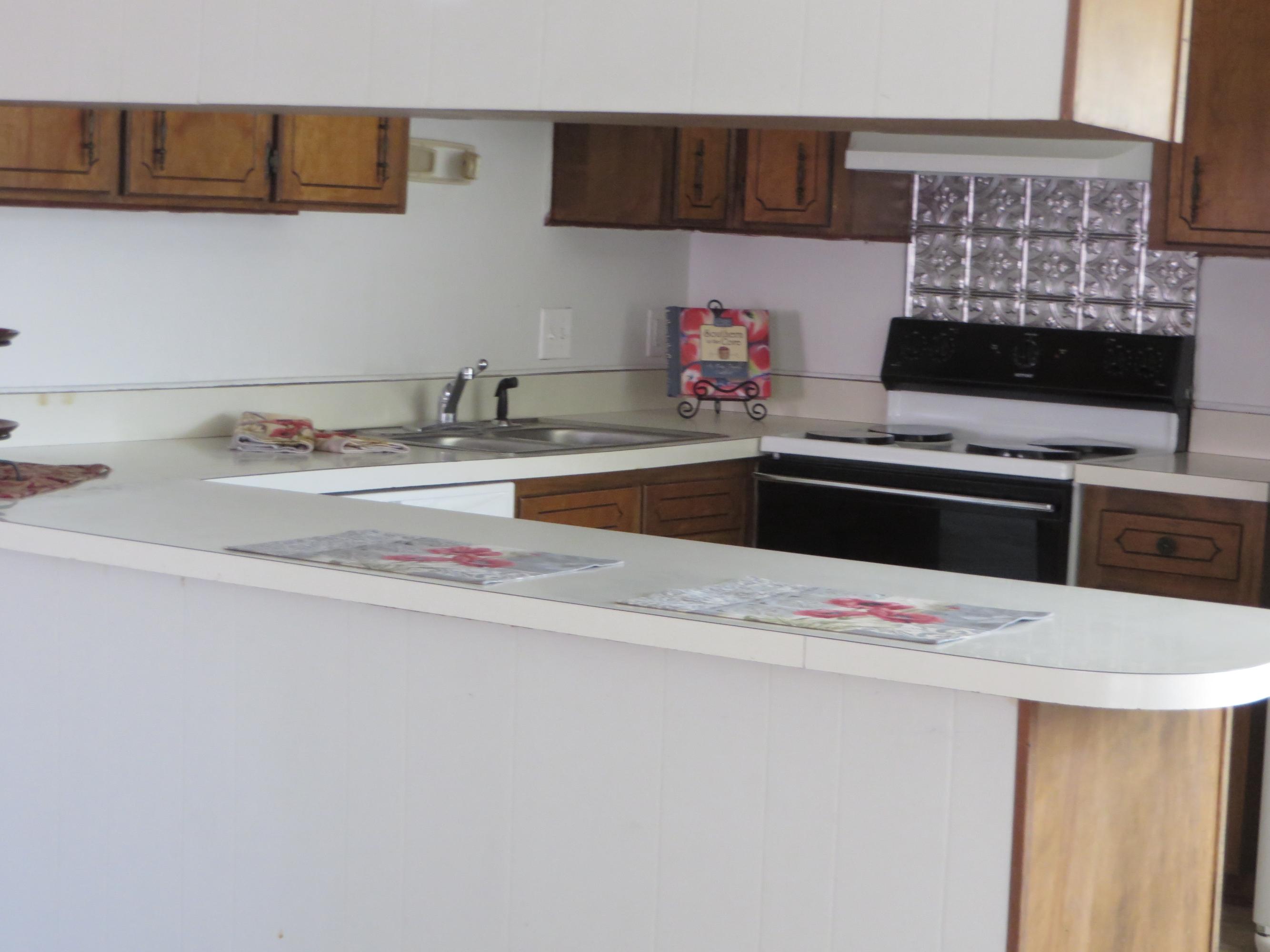 135 Perdido Circle Niceville, FL 32578 - Photo 24 of 28 a kitchen with a sink and cabinets